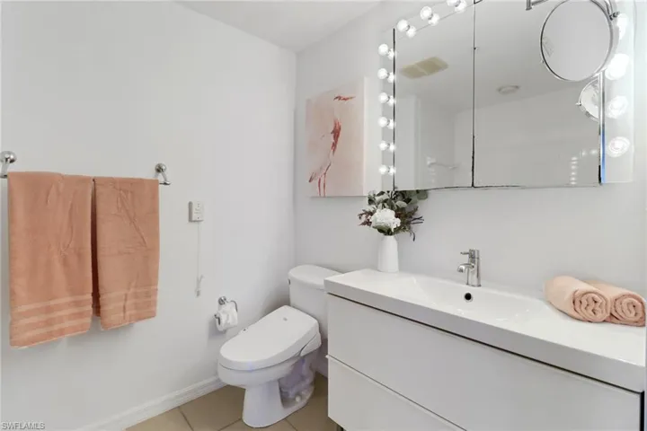 Bathroom with tile patterned floors and vanity