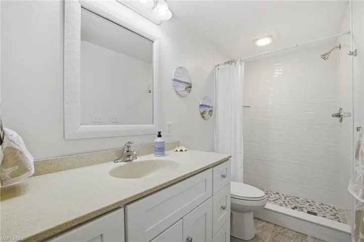 Bathroom with vanity and a shower stall
