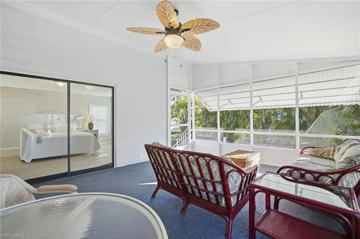 Sunroom / solarium with ceiling fan and an outdoor hangout area
