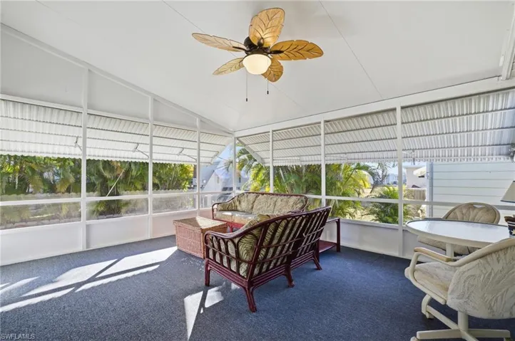 Screened Lanai with a ceiling fan, vaulted ceiling, an outdoor living space with private yard