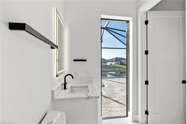 Full bathroom with a marble finish shower, light marble finish flooring, vanity, and a ceiling fan
