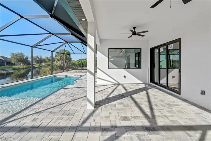Foyer entrance featuring french doors, light marble finish flooring, and a high ceiling