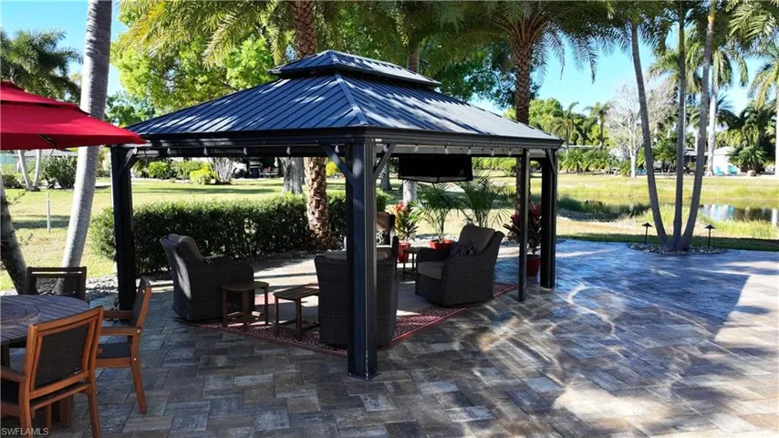 View of patio / terrace with a gazebo, a water view, and outdoor furniture