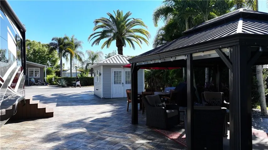 View of patio / terrace featuring an outdoor hangout area, a gazebo, grilling area, and an outdoor structure