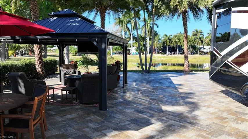 View of patio with a gazebo and a water view