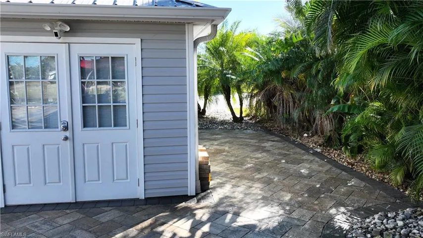 Entrance to property featuring a patio and a metal roof