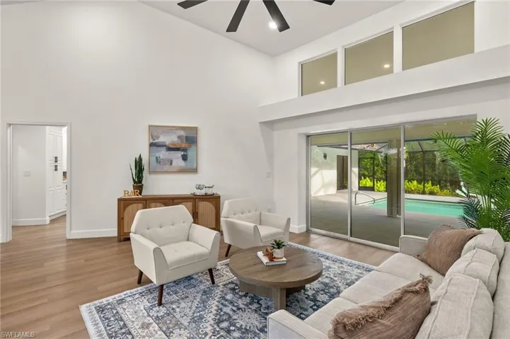Formal Living Room with oversized Glass over the Triple Pocket Sliders and New LVP Flooring