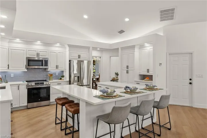 There are 2 Free Standing Pantries, Upper Header LED Accent Lighting, Black Hardware