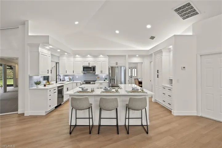 New Kitchen with Quartz Counters, GE S/S Appliances, White Raised Panel Wood Cabinets, Subway Backsplash