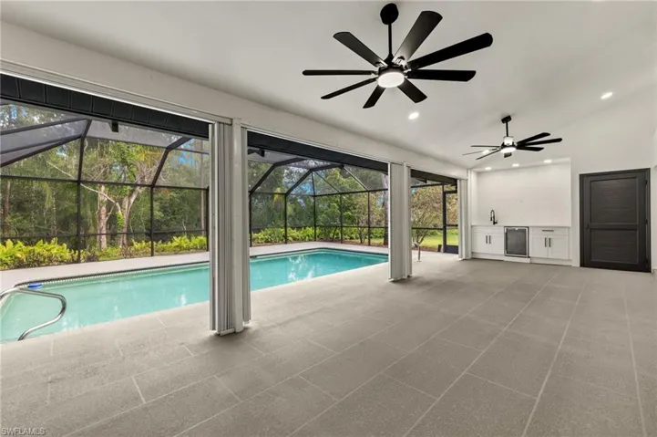 New Pool Deck with 18x36 Large Format Design & Custom Outdoor Kitchen with Sink & Beverage Fridge