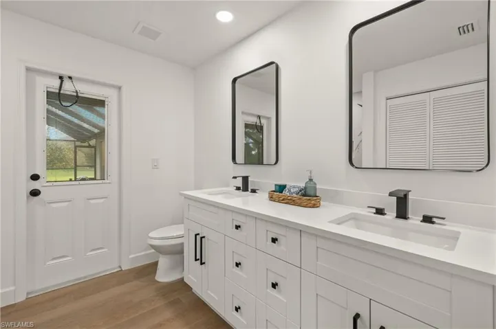 Full Guest Bath with dual vanities, Quartz Counters, Black Mirrors, and 24x48 Shower Tiles with a new Tub