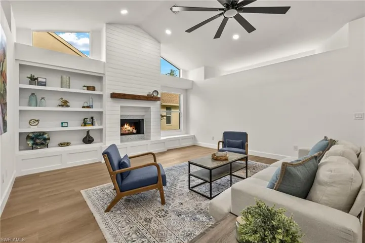 Family Room has a Newly Renovated/Certified Wood Burning Fireplace with Horizontal Shiplap & a Wood Mantle