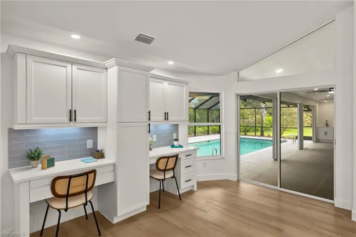 This Custom Built area off the Kitchen is perfect for a kids work station, has Under Cabinet Lighting, a Pantry, etc.