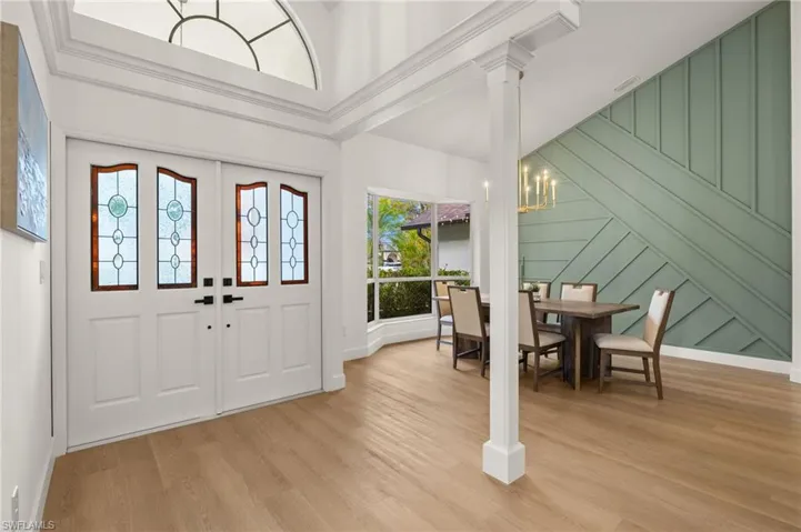 Front Entry with Custom Stained Glass Doors, Crown Molding & a Custom Wood Focal Wall