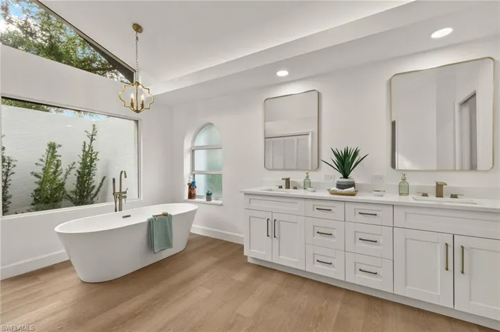 New Primary Bath has a Large White Shaker Vanity w/Dual Sinks, Quartz Counters, a Free Standing Tub