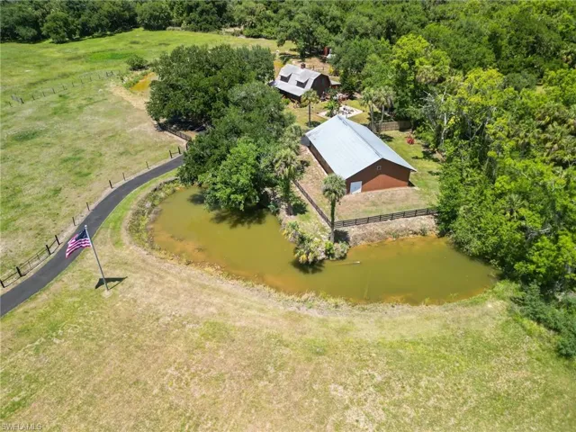 Birds eye view of property with a water view