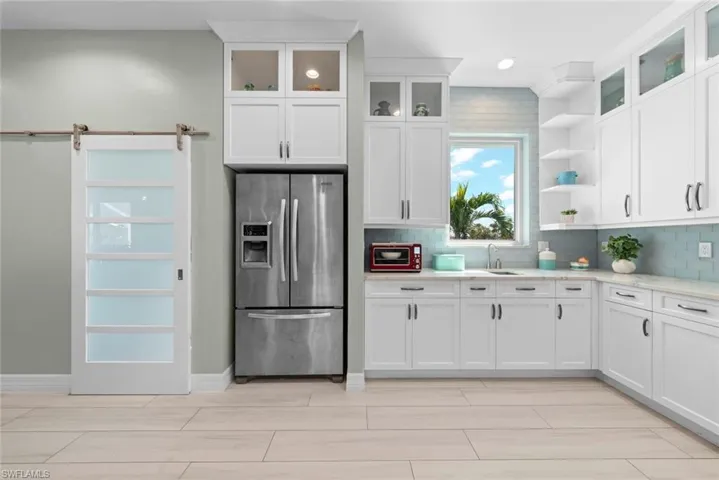 Kitchen with white countertops, stainless steel appliances