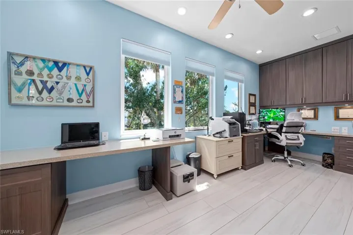 Home office with built-in desk and cabinetry