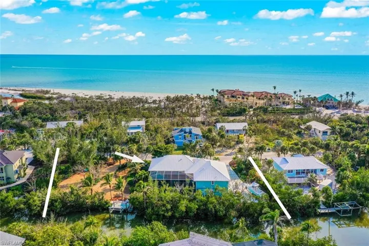 Aerial view of property, canal, and Gulf