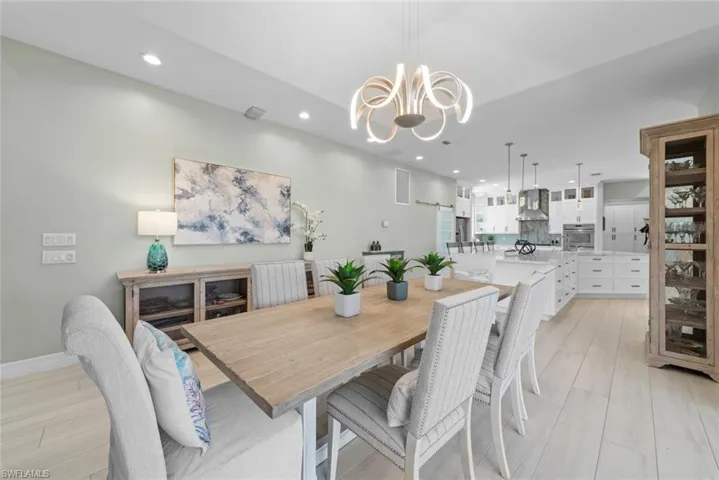 Dining space with a notable chandelier and recessed lighting