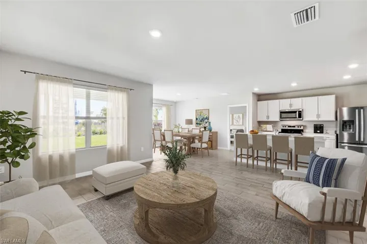 Virtually Staged- Living room featuring wood tiled floors and recessed lighting