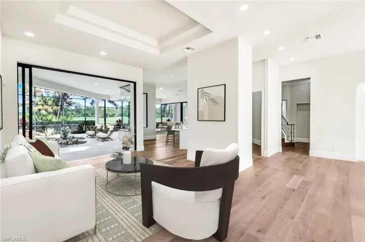 Living room VIRTUALLY STAGED & Furnished overlooking pool and golf course.
