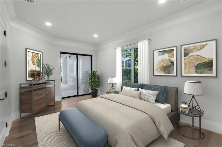 VIRTUALLY STAGED Bedroom #2 featuring hardwood floor, private bath & access to pool/lanai.