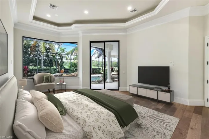 Master Bedroom VIRTUALLY STAGED   with access to exterior, a tray ceiling, dark wood-type flooring, and ornamental molding