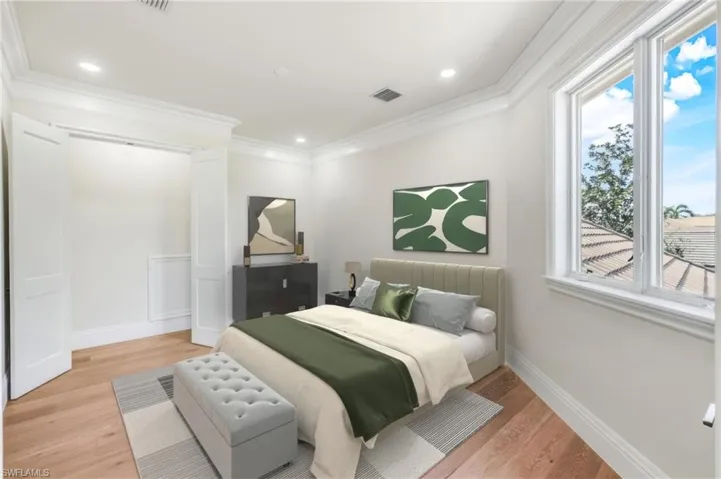 VIRTUALLY STAGED Bedroom 4 with private bath featuring ornamental molding and light wood-type flooring