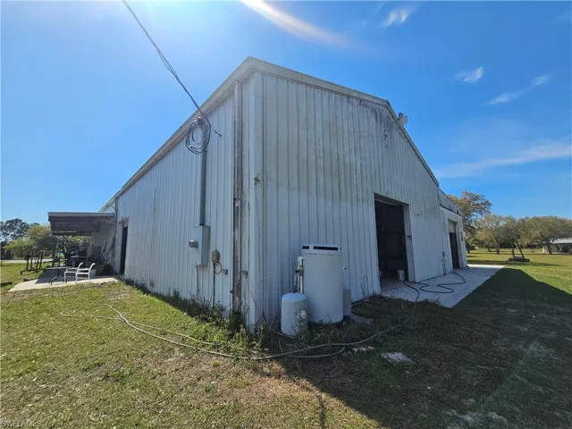 View of pole building with a lawn
