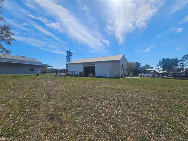 View of yard featuring an outbuilding and a pole building