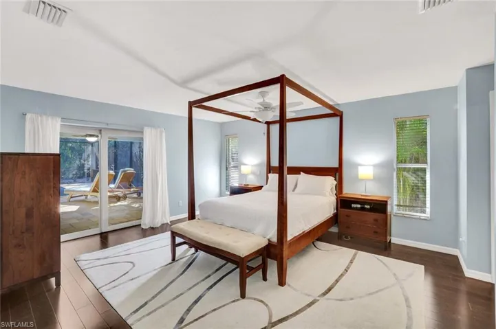 Large primary bedroom with sliders to patio