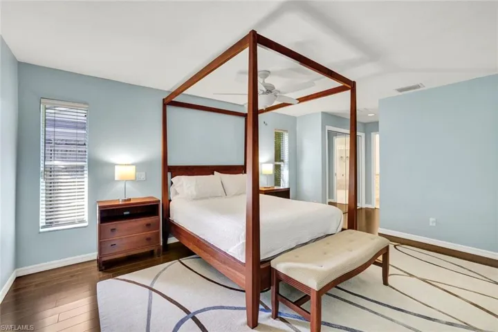 Wood floors flow into the en suite bathroom