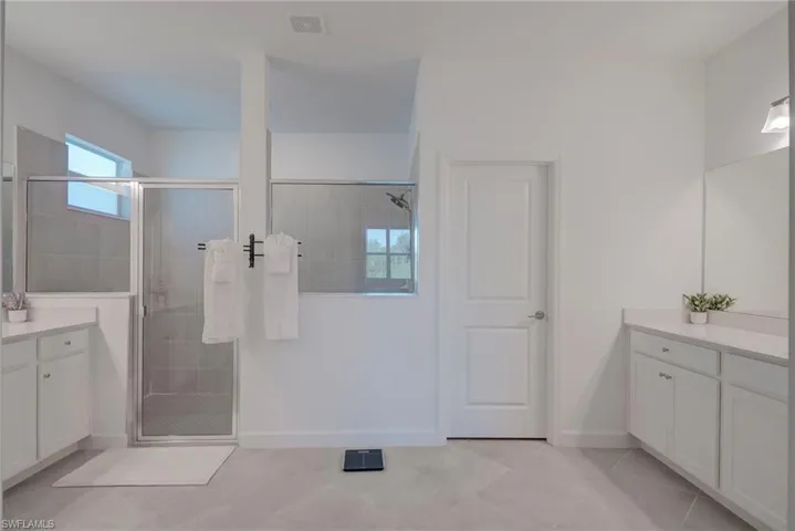 Full bathroom featuring vanity and a stall shower