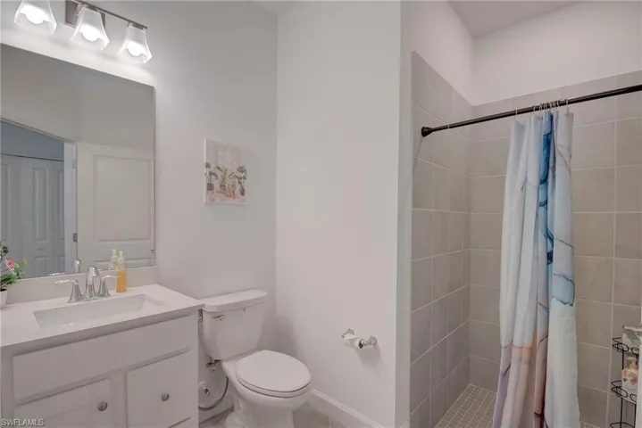 Bathroom featuring vanity and a shower stall