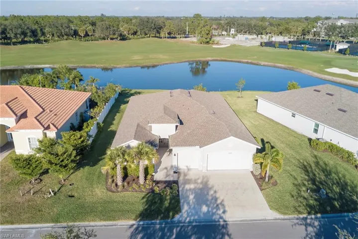 Drone / aerial view of a golf course and a large body of water