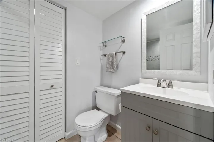 Bathroom with tile patterned floors, vanity, and toilet