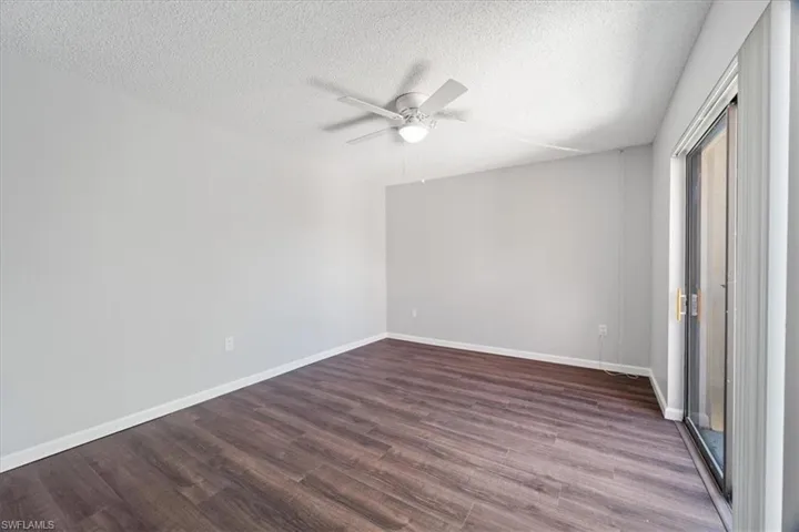 Unfurnished bedroom featuring a textured ceiling, hardwood / wood-style flooring, and ceiling fan