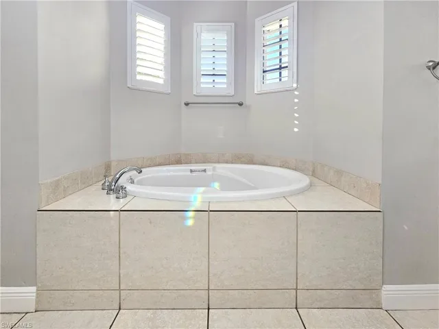 Bathroom with a bath and tile patterned flooring