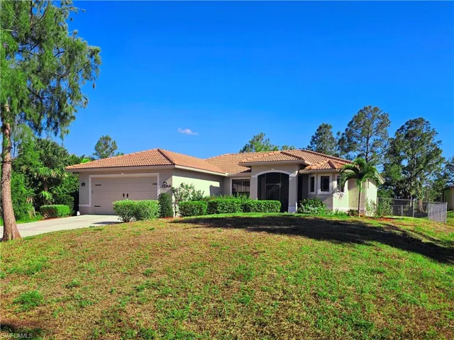 Mediterranean / spanish-style home with a tile roof, stucco siding, a garage, and concrete driveway