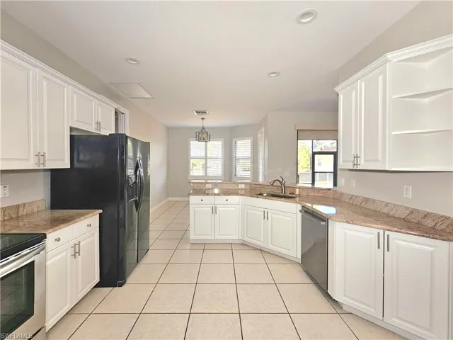Kitchen with stainless steel appliances, a peninsula, white cabinetry, open shelves, and recessed lighting