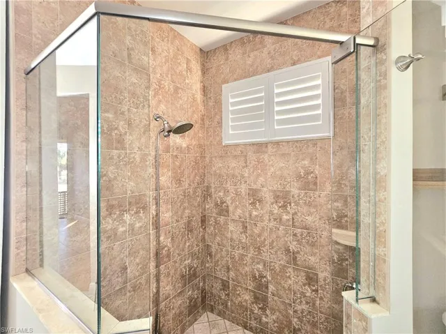 Full bathroom with a shower stall