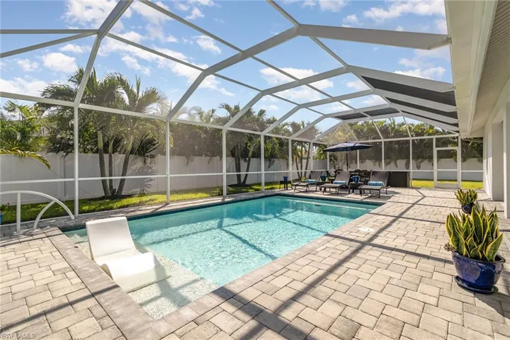 View of pool featuring a lanai with pavers.