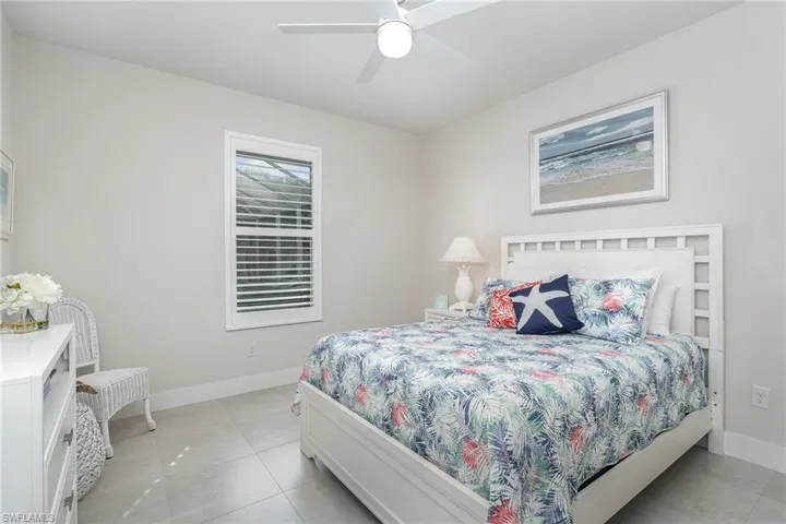 Tiled bedroom with ceiling fan