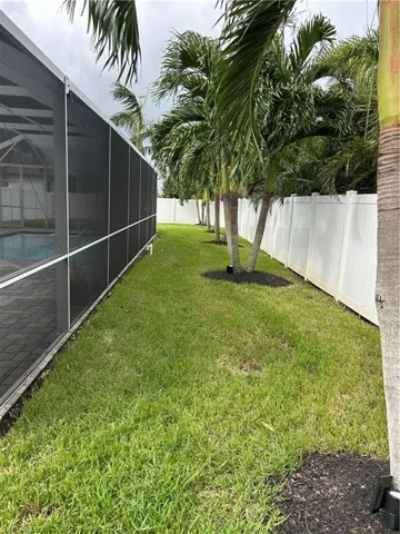 View of yard with glass enclosure