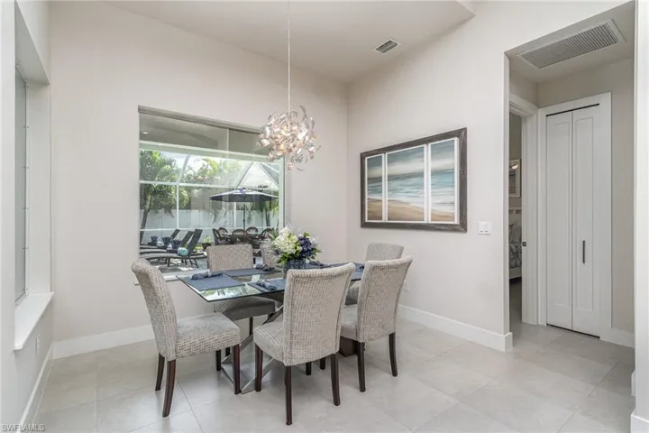 Tiled dining room featuring a chandelier