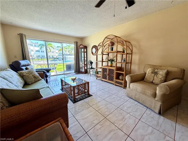 Living room with plenty of natural light and sliding glass door out to pool area