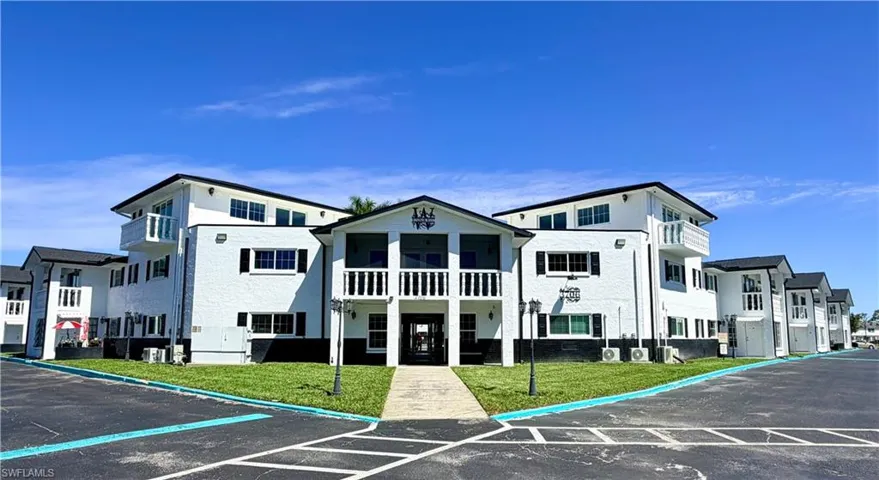 View of property featuring uncovered parking