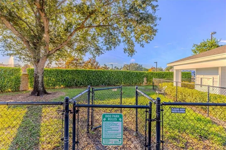 View of yard featuring a dog friendly area, a gate, and agricultural area