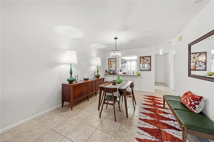 Tiled dining space with a notable chandelier